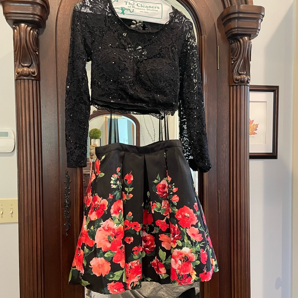 Split formal dress with lace detailing.